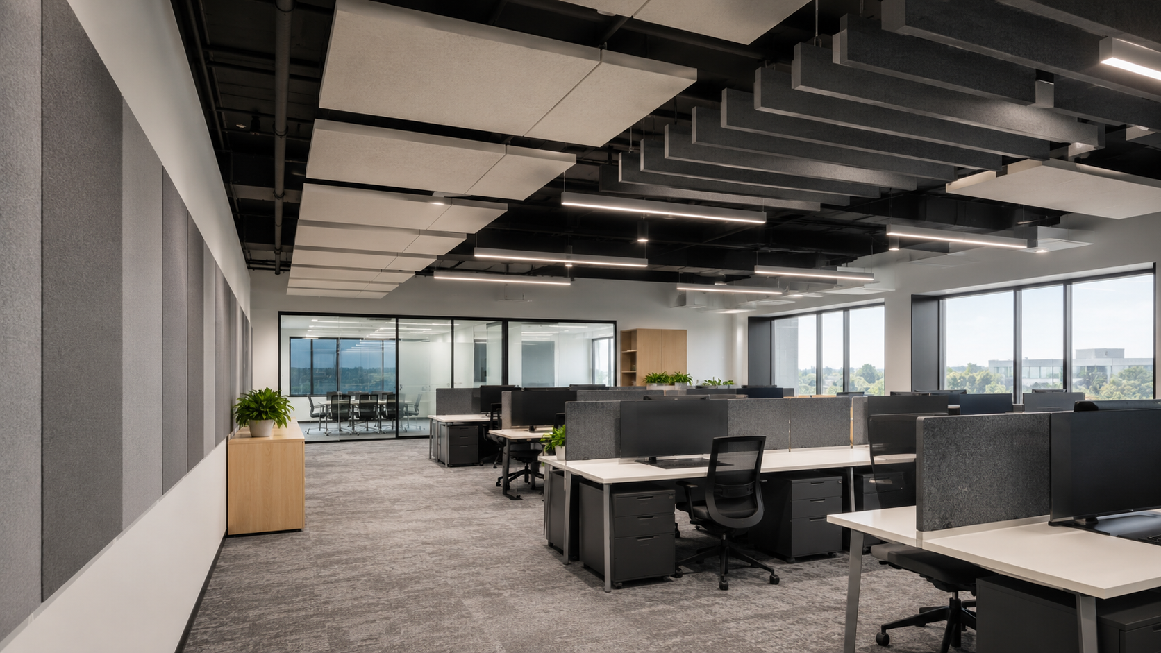 Open-plan office with suspended acoustic ceiling clouds and wall panels